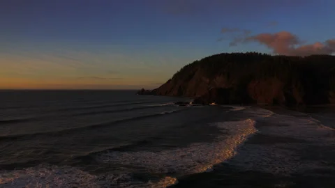 Drone flying through the sunset of Canon Beach, Oregon Stock Footage 145819897