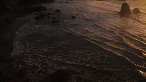 Drone flying through the sunset of Canon Beach, Oregon Stock Footage 145820406