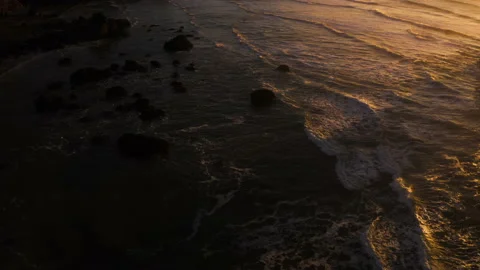 Drone flying through the sunset of Canon Beach, Oregon Stock Footage 145820433