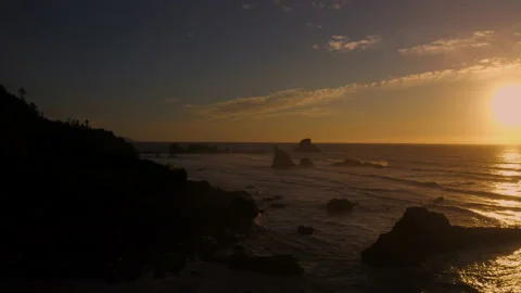 Drone flying through the sunset of Canon Beach, Oregon Stock Footage 145820445