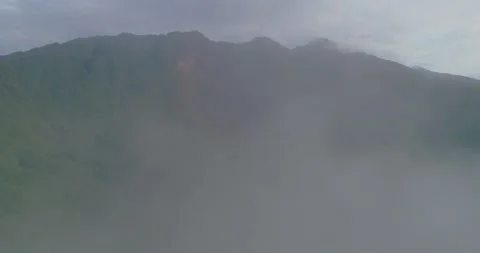 Drone flying through thick fog revealing tropical mountain waterfall and forest Stock-Footage 333223966