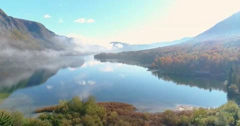 Drone flying through thin fog over beautiful Alpine lake in Slovenia Stock Footage 147487187