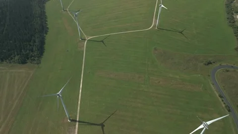 Drone Flying Through Valley of Wind Turbines with Downward View Stock Footage 314940432