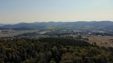 Drone flying towads small rural town at base of mountains Stock Footage 122177183