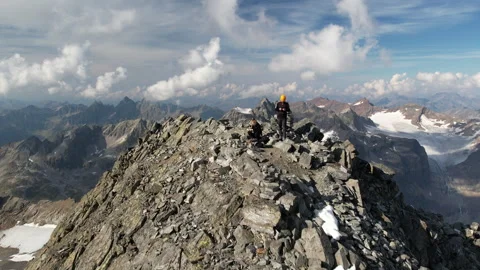 Drone flying toward and over mountaineers on a mountain peak 2 Stock-Footage 325328764