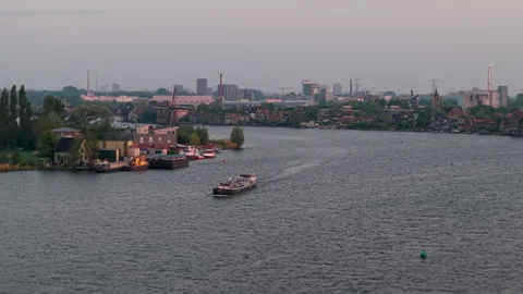 Drone Flying Toward Dutch River Boat on the Zaan at Sunset in Zaandijk Stock-Footage 309313669