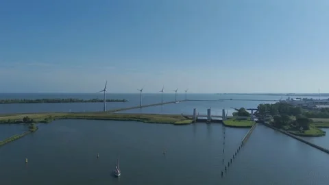 Drone Flying Toward Krabbersgat Lock and Wind Turbines Stock Footage 339682856