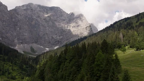 Drone Flying Toward Limestone Cliffs Above Alpine Forest in Eng Alm Valley Stock Footage 340485888
