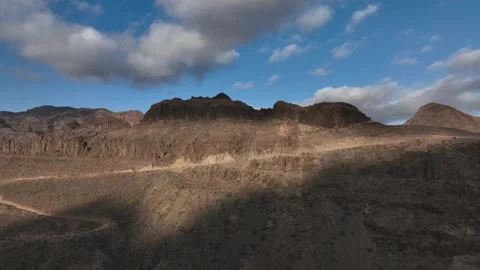 Drone Flying Toward Mountain Wall with Road and Rugged Cliffs – Gran Canaria Stock Footage 309951494