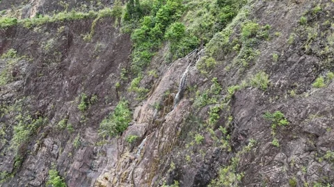 Drone flying toward mountain waterfall at Khanh Le Pass, Vietnam 動画素材 337400401