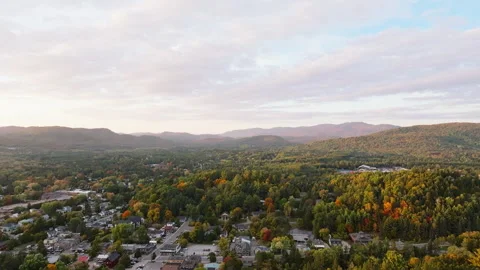 Drone Flying Toward Mountains at Sunset Over Autumn Town Stock Footage 321379211