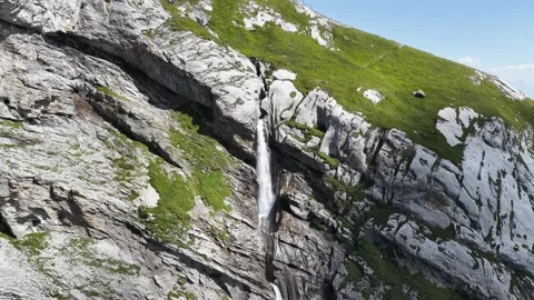 Drone flying toward Segnesboden waterfall and cliffs near Flims in Swiss Alps Stock Footage 320088198