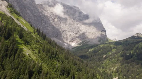 Drone Flying Toward Sunlit Limestone Cliffs in Eng Alm Valley Austria Stock Footage 340486195