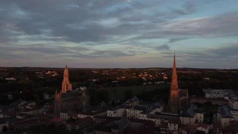 Drone Flying Toward Two Churches with Sunlit Spires in France Cinematic View Stock Footage 331661575