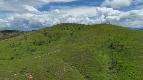 Drone flying toward vast green hills of Pa Sol grasslands 스톡 동영상 337046669