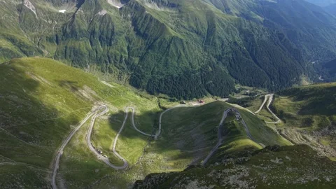 Drone flying toward winding road between  Mountain peaks 스톡 동영상 340824470