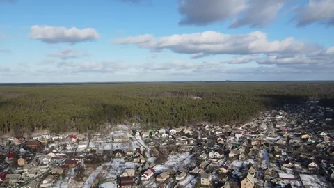 Drone Flying Toward Winter Forest Over Snowy Town Stock Footage 318941034
