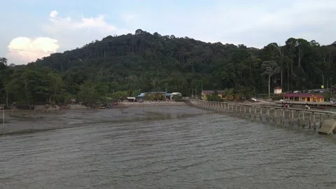 Drone flying towards beach and fishing boat in Teluk Kemang Stock Footage 150722832
