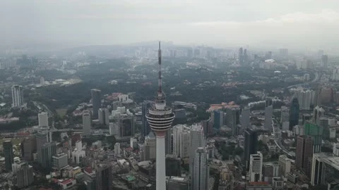 Drone flying towards communications tower in Kuala Lumpur Stock Footage 150289965