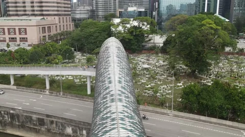 Drone flying towards graveyard and passing through bridge in Kuala Lumpur. Stock Footage 150289517