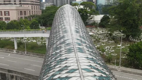 Drone flying towards graveyard and passing through bridge in Kuala Lumpur Stock Footage 150290673