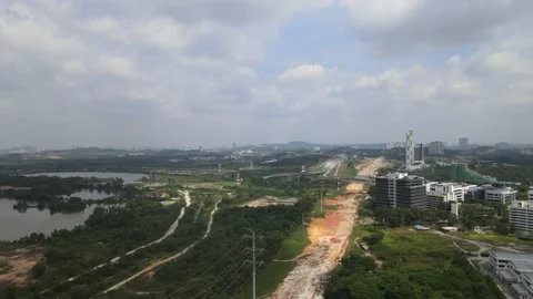 Drone flying towards highway and lake in Cyberjaya Stock Footage 149380598