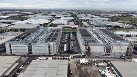 Drone flying towards a large data center construction site Video stock 337810542