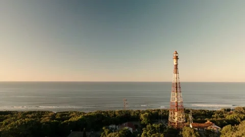 Drone  flying towards an old rusty lighthouse at sunrise. Stock Footage 151469634