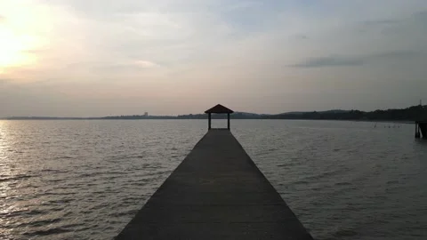 Drone flying towards rest house on the jetty in Teluk Kemang Stock Footage 150722183