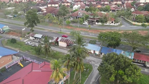 Drone flying towards road and follow red car in Kajang Stock Footage 150749029