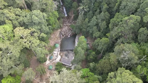 Drone flying towards small pool and waterfall in Jelebu Stock Footage 149718285