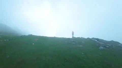 Drone flying towards subject in mountains, fog clouds mist Video stock 252071853