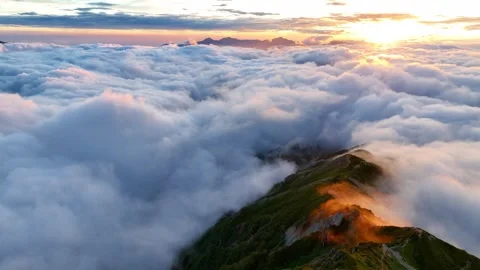 Drone is flying towards the sun on a beautiful morning in the mountains, idyllic Stock Footage 247745211