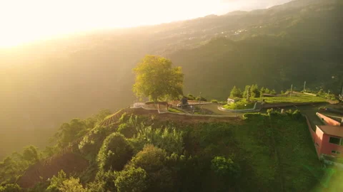 Drone flying towards sunrise over a car with roof top tent in Madeira Vídeos de archivo 328640992