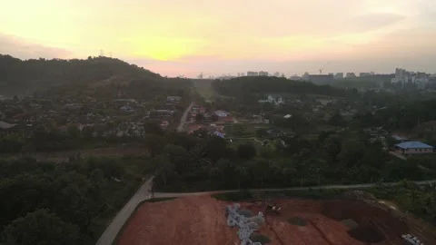 Drone flying towards sunset in Desa Pinggiran Putra Stock Footage 150747665