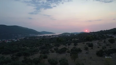 Drone flying towards a sunset over typical Dalmatian landscape Stock Footage 100722617