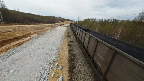 Drone flying towards a train with coal wagons Stock Footage 235823443