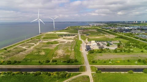 Drone flying towards two big wind mills at an environmental center in Copen.. Stock Footage 278364208