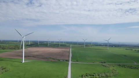 Drone Flying Towards a Wind Farm overlooking a field Stockbeeldmateriaal 197569047