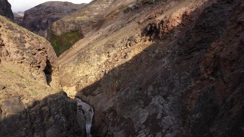 Drone Flying Trough A Deep Gorge. Canyon With Waterfall. Kamchatka Peninsula.   Stock Footage 128669679