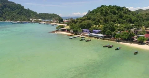 Drone flying under the boats and amazing clear water at Phi-Phi island. Aerial Video stock 75736360