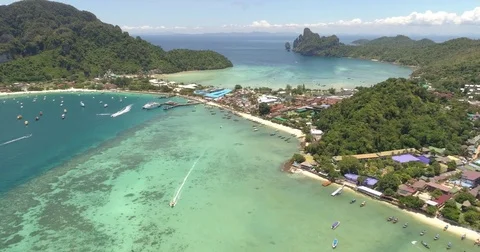 Drone flying under the boats and amazing clear water at Phi-Phi island. Aerial Video stock 75768190
