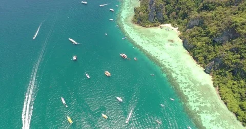 Drone flying under the boats and amazing clear water at Phi-Phi island. Stock Footage 75875845