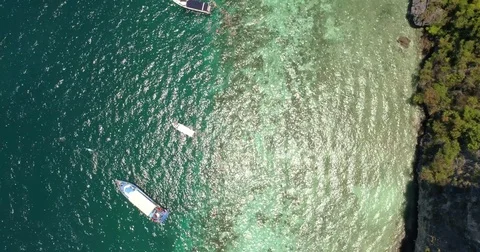 Drone flying under the boats and amazing clear water at Phi-Phi island. Stock Footage 75875876