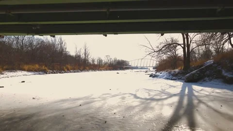Drone flying under bridge and frozen river Stock Footage 171954511