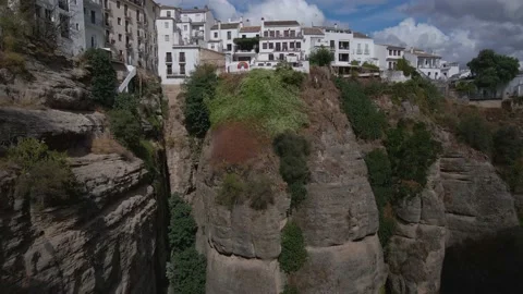 Drone is flying under the massive bridge, cityscape of Ronda, Spain, 4k Stock Footage 164858780