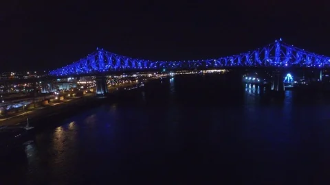 Drone flying underneath lit-up bridge with traffic at night - 24fps 1080p Video stock 104064585