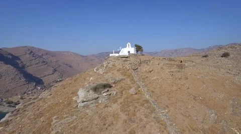 Drone flying uphill to small perfect wedding spot Cyclades summer island Greece Video stock 55523171