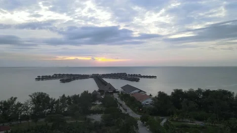 Drone flying upward with view sunset and luxury hotel Stock Footage 149623565