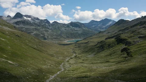 Drone flying in Val Loga - View on Montespluga Lake Town and Pizzo Suretta Stock-Footage 253500422